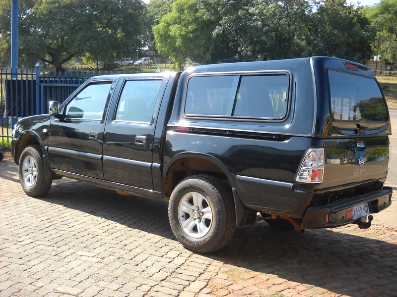 Black GWM double cab with a colour-matched canopy.