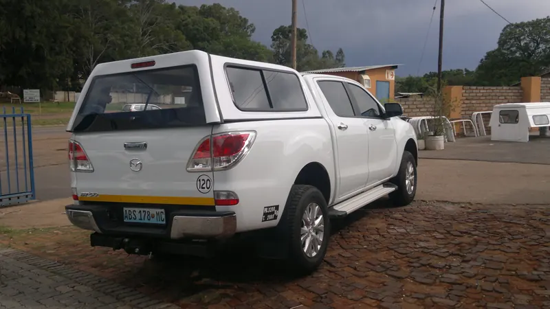 White Mazda BT-50 double cab with a colour-matched canopy.