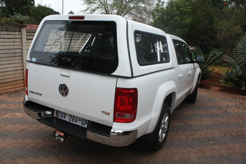 White Volkswagen Amarok double cab with canopy