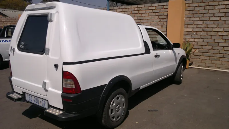 White Fiat Strada with a Space Saver canopy.