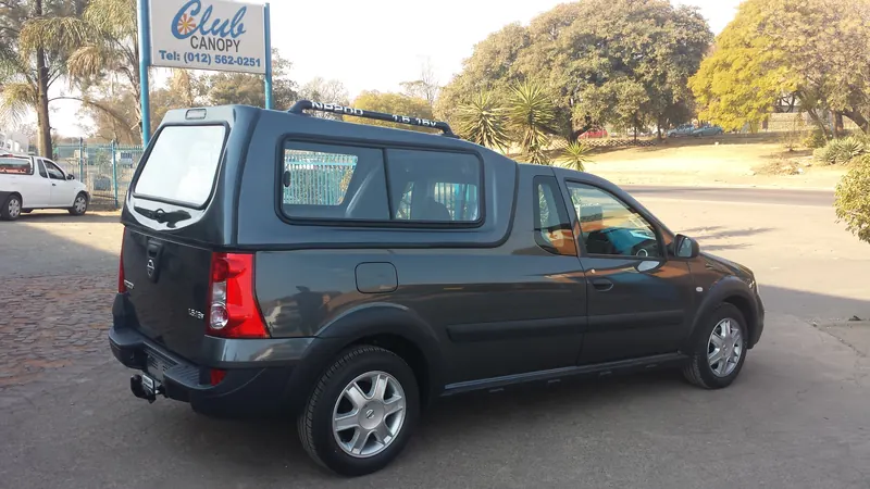 Grey Nissan NP200 with a colour-matched canopy and roof rails.