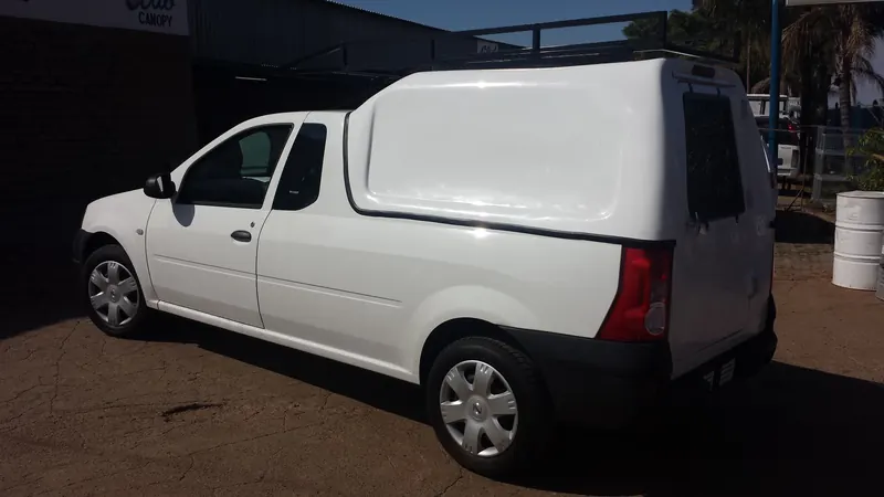 White Nissan NP200 with a Space Saver canopy.