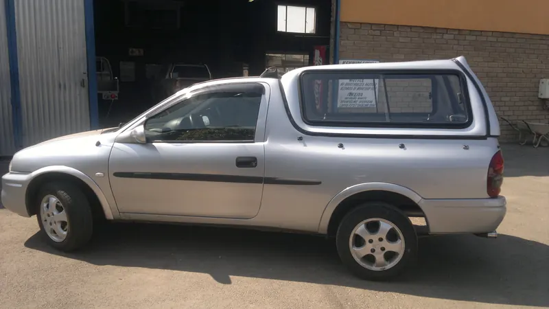 Silver Opel Corsa Utility with a colour-matched canopy.
