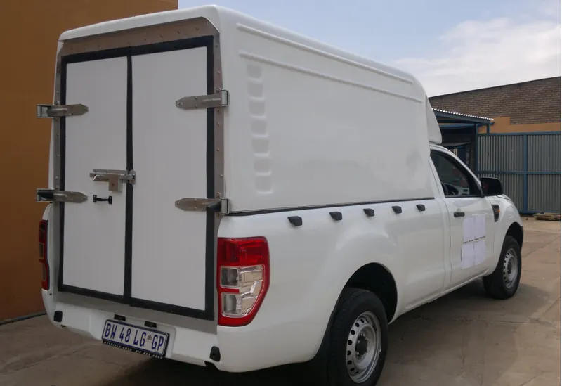 White Ford Ranger with a Space Saver canopy and double rear doors.