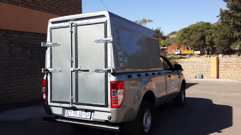 Silver Ford Ranger with a colour-matched Space Saver canopy and double rear doors.