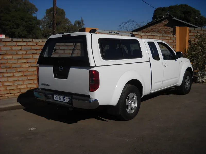 White Nissan Navara with a colour-matched canopy.