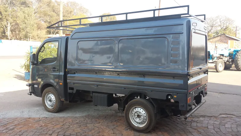 Grey Tata Super Ace with a colour-matched canopy and steel roof rack.