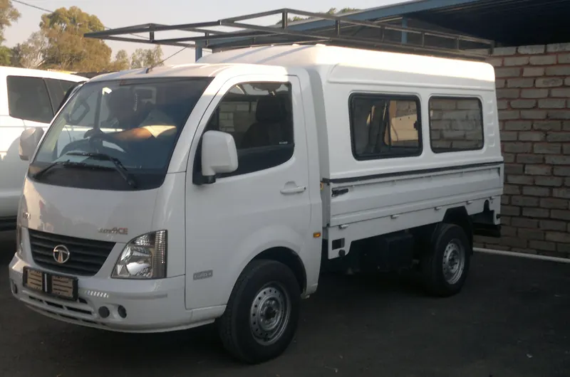 White Tata Super Ace with canopy and steel roof rack, front view.