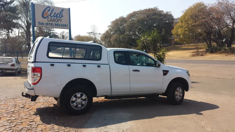 White Ford Ranger SuperCab with a colour-matched canopy, rear three-quarter view.