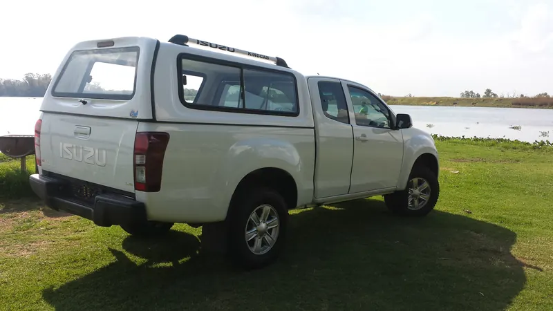 White Isuzu KB Extended Cab with Full House canopy, rear view.