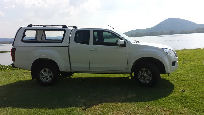 White Isuzu KB Extended Cab with a Full House canopy and roof rack
