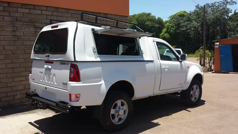 White Tata Xenon single cab with canopy, lift-up side window and roof rack.